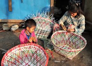 In Mai Nai IDP camp, a resident weaves baskets to generate income.