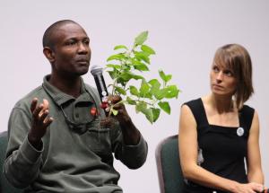 During the panel discussion after the Migrant Dreams screening, facilitator and Inter Pares staff member Samantha McGavin looks on while farmworker Gabriel Allahdua uses a plant to illustrate the systemic discrimination that he and his peers experience.