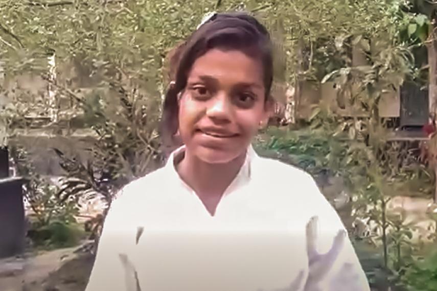 grainy photo of a young girl in a karate uniform.