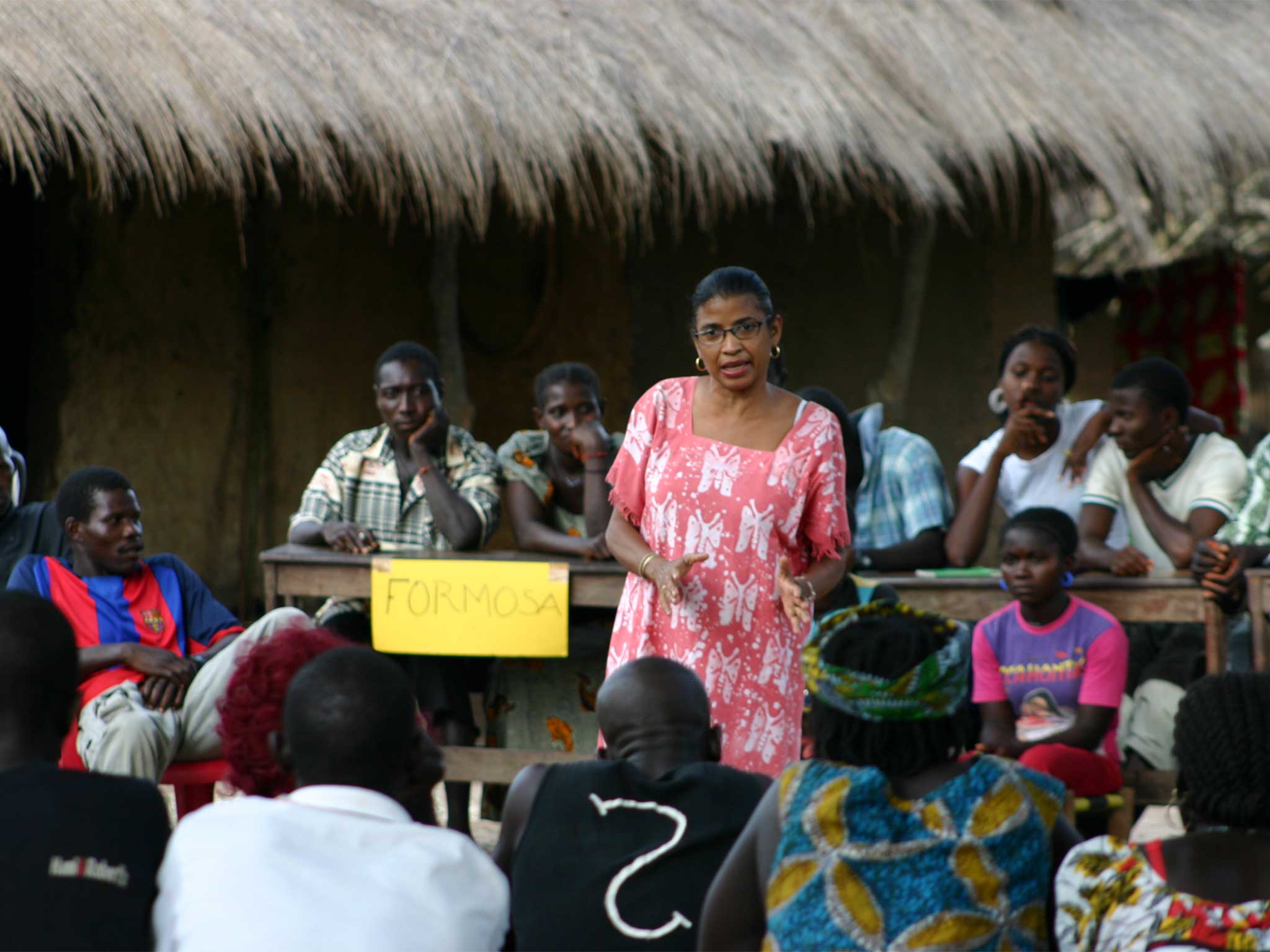 Photo of a woman standing before and speaking to a crowd. Donate to Inter Pares a Canadian registered social justice charity and support women's leadership around the world.