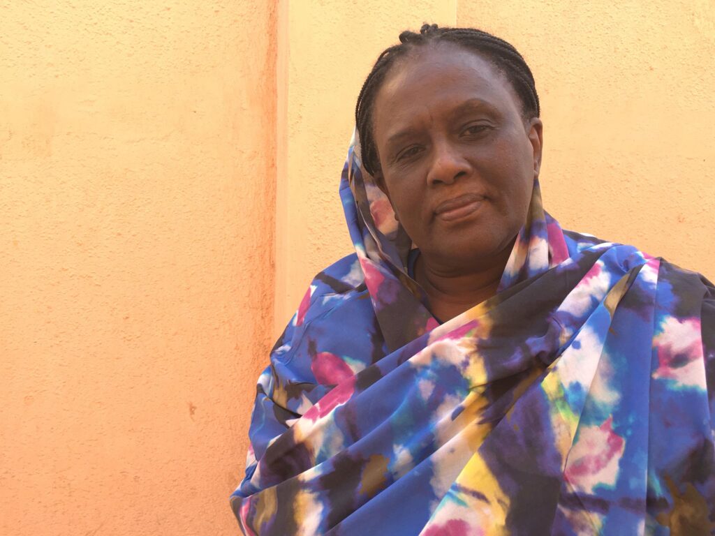 Sudan war: Donate now to support the woman in this photo, Ilham. Here she looks serious and determined.